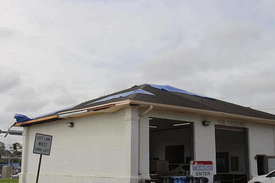A commercial building with a low-slope roof under repair