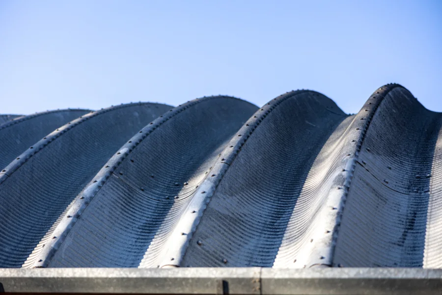 Curved metal roof panels on a large building
